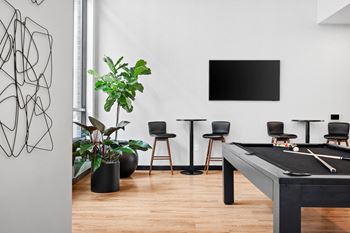 a game room with a pool table and a tv